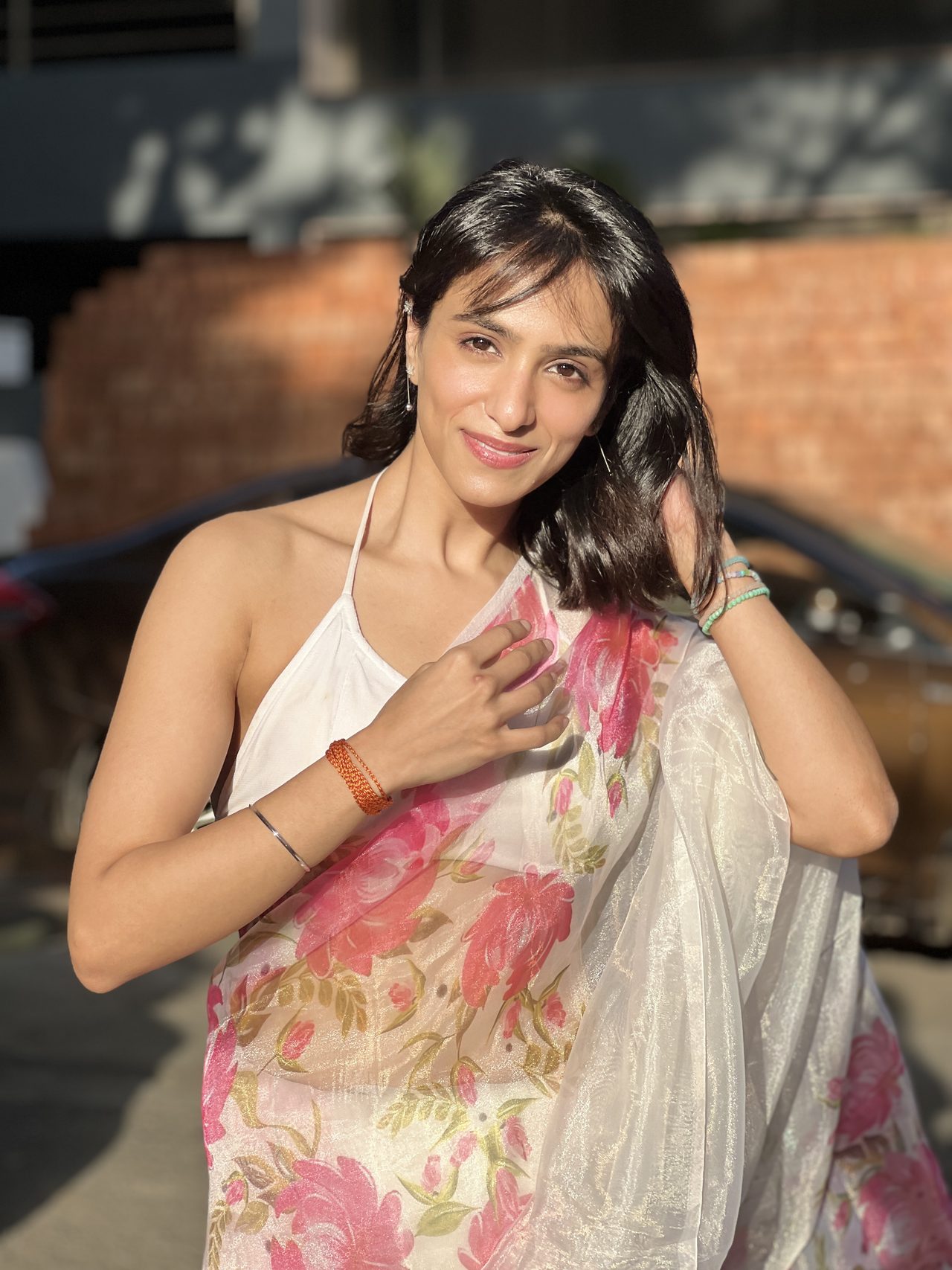 Siffaat Gandhi — sheer floral saree, soft daylight, smile