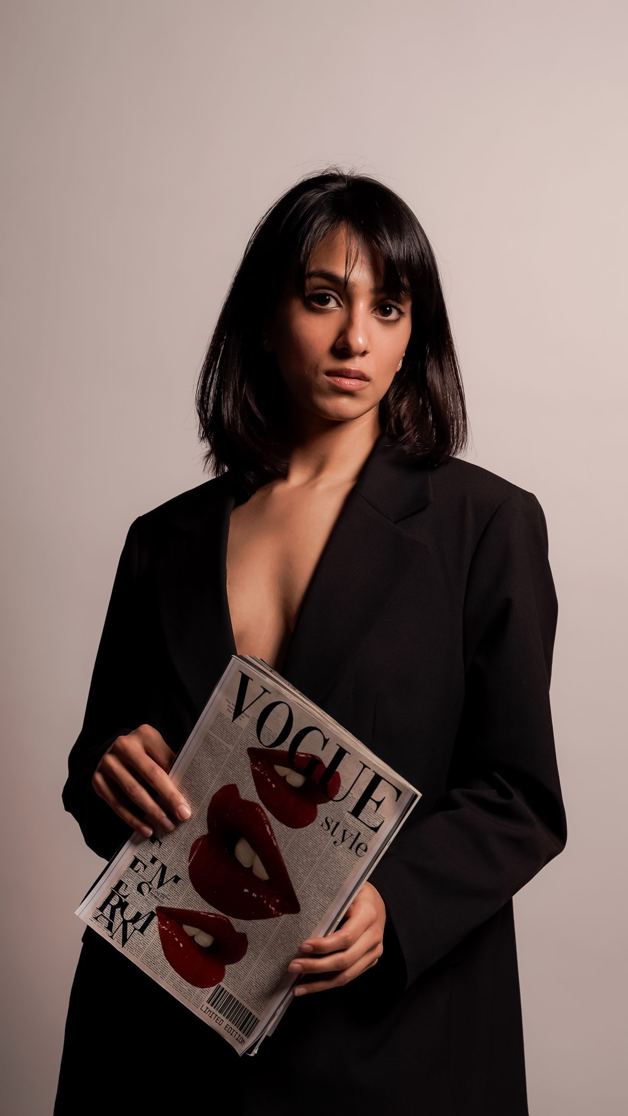 Siffaat Gandhi — composed front portrait, black blazer, studio light