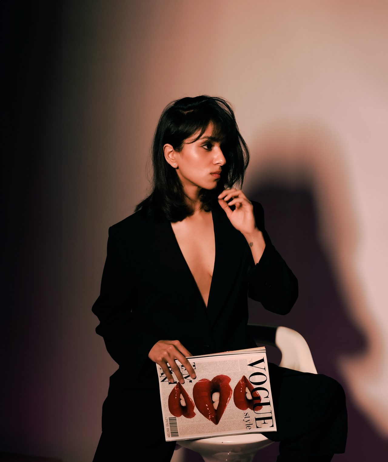 Siffaat Gandhi — editorial side profile, black blazer, studio shadow